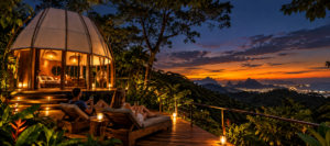 Couple relaxing on a wooden deck beside an illuminated rainforest dome overlooking Rio de Janeiro at sunset.