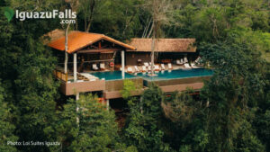 Glamping structures in a lush rainforest with a private pool and lounge chairs on a deck