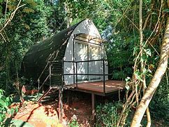 Panoramic view of Iguazú Falls with cascading waterfalls surrounded by lush tropical rainforest.