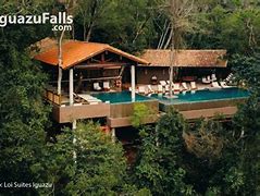 Glamping structure with chairs and pool in a rainforest.