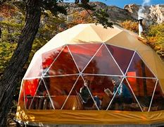 Chaltén Camp – El Chaltén, Argentina 2 Glamping dome structure with people sitting down inside on chairs in the mountains