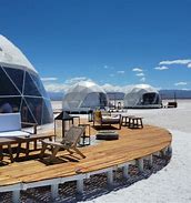 Pristine Salinas Grandes – Argentinian the High Plains 2 Several Glamping domes with tables and chairs on a platform in the wintertime