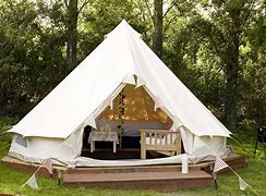 Glamping structure in a rainforest with a grill.