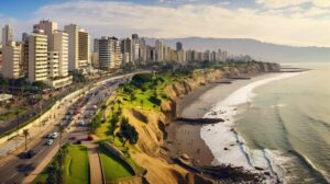 Coast with sandy beaches next to the ocean with trees and vegetation and a city with buildings