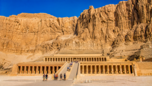 Karnak Temple – Luxor, Egypt: Gateway To Ancient Wonders 19 Temple of Hatshepsut near Luxor, Egypt, featuring its grand terraces, sandstone columns, central ramp, and towering desert cliffs.