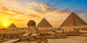 Karnak Temple – Luxor, Egypt: Gateway To Ancient Wonders 21 Great Sphinx and Giza Pyramids in Egypt at sunset, surrounded by the golden desert landscape beneath a dramatic sky.