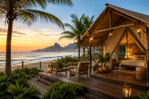 ✨ Rio De Janeiro Glamping Hub: Luxury Nature Stays in Brazil’s Most Vibrant City 15 Luxury beachfront safari glamping tent with a wooden deck, palm trees, ocean views, and sunset scenery representing Barra da Tijuca, Rio de Janeiro, Brazil.