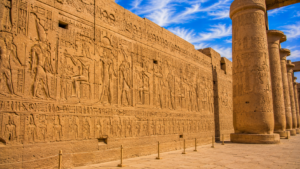 Karnak Temple – Luxor, Egypt: Gateway To Ancient Wonders 13 Ancient hieroglyphs and detailed carvings covering sandstone temple walls and columns at Karnak Temple in Luxor, Egypt.
