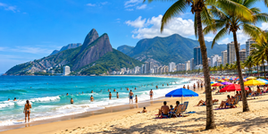 ✨ Rio De Janeiro Glamping Hub: Luxury Nature Stays in Brazil’s Most Vibrant City 2 Panoramic illustration of a sunny Rio de Janeiro beach with golden sand, turquoise Atlantic Ocean waves, colorful umbrellas, palm trees, beachgoers, and tropical mountains.