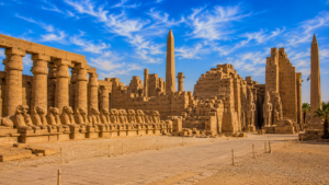 Karnak Temple – Luxor, Egypt: Gateway To Ancient Wonders 14 Precinct of Amun-Ra at Karnak Temple in Luxor, Egypt, featuring ancient columns, obelisks, ram-headed sphinxes, pharaoh statues, and sandstone temple ruins.