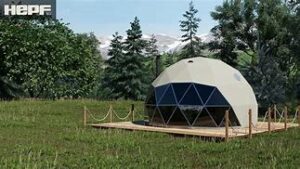 Nature Domes In Lunahuaná Valley 2 Glamping dome on a platform in a field with a forest.