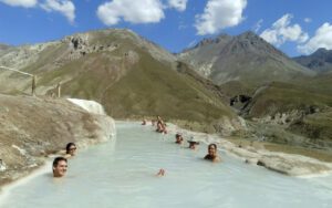 Several People laying in whitewater in the Andes mountains