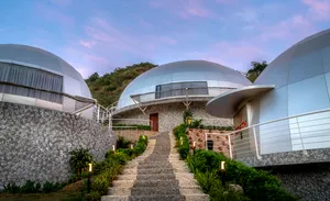 Organic Farm Dome Stay, Maras: Sustainable Living Amidst Andean Beauty 3 Modern luxury dome accommodations with landscaped walkways and mountain greenery at a glamping retreat.