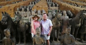 ⚔️ The Terracotta Army, Xi’an: Guardians Of China’s First Emperor🌏 3 A man and woman posing for a photo among the life-sized Terracotta Army statues in Xi’an, China.