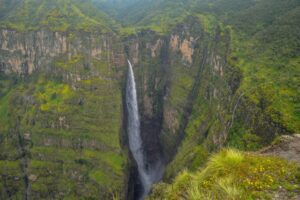 Simien Mountains National Park – Ethiopia’s Roof of Africa 3 A breathtaking waterfall cascading through Ethiopia’s lush highlands, surrounded by dramatic cliffs and verdant vegetation.