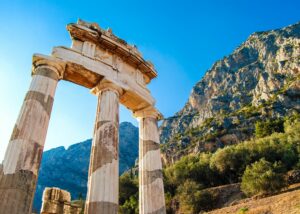 🌿 Discover Olympia: Birthplace of The Ancient Olympic Games in Greece 2 Three tall ancient pillars standing against a clear sky, remnants of a historic Greek temple
