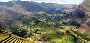 Scenic view of the Sacred Valley of the Incas in Peru, with lush green terraces, mountains, and Inca ruins, perfect for a holiday or winter adventure.