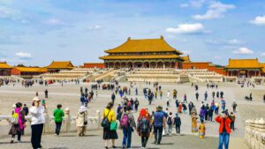 🏯 The Forbidden City, Beijing: Step Inside China’s Imperial Heart🌏 4 Visitors walking down a ramp into a large courtyard at the Forbidden City in Beijing, China.