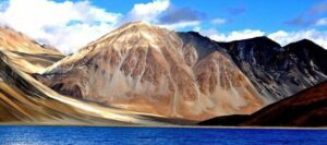 Scenic view of a lake surrounded by mountains in Leh, Ladakh.