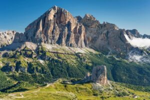 Panoramic view of Gruppo del Nuvolau in the Dolomites, Italy, with rugged peaks, alpine meadows, and historic mountain huts.