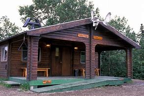Brooks Lodge in Katmai National Park, Alaska, with forested surroundings and mountains in the background.
