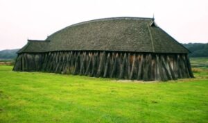 Viking Longhouses: Homes Of The NorseViking Longhouses Were The Central 2 Reconstructed Viking longhouse with wooden walls and thatched roof, showing interior living and communal spaces.
