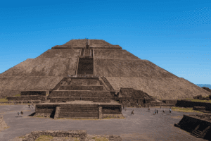 Pyramid of the Sun at Teotihuacan, Mexico – view of the ancient Mesoamerican pyramid with stairs leading to the top under a blue sky.