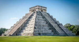 El Castillo, the Pyramid of Kukulkan at Chichen Itza in Mexico – iconic Mayan step pyramid under a bright sky.