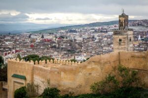 Ancient fortress ruins atop a hill with weathered stone walls and panoramic views.