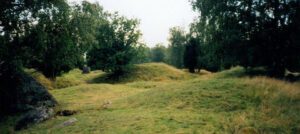 Birka Burial Mounds: Unearthing Viking History in Sweden 1 Birka archaeological site showing Viking trading center remains alongside burial mounds and grave sites in Sweden.