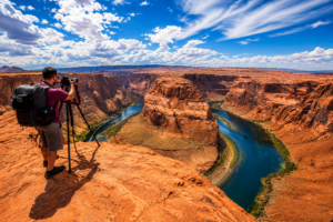 🐎 Horseshoe Bend (Page, Arizona) RV-Friendly Travel Tips, Scenic Overlook Guide 4 Photographer standing at the edge of Horseshoe Bend capturing panoramic views of the winding Colorado River surrounded by towering red rock canyon cliffs beneath dramatic blue desert skies.