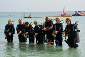 Seven scuba divers gearing up for an unforgettable Red Sea adventure — preparing to explore vibrant reefs and marine life 🐠🏝️