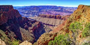 🌄 Lipan Point – Grand Canyon South Rim Overlook 1 Panoramic view from Lipan Point on the Grand Canyon South Rim, showing steep canyon walls, layered rock formations, and a river snaking through the valley under a clear blue sky.