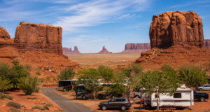 Monument Valley: Iconic Red Rock Landscape of The American Southwest 3 RV campground in Monument Valley with campsites surrounded by towering red sandstone buttes and breathtaking desert scenery.