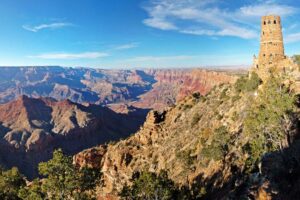 🏛️ Desert View Watchtower – Grand Canyon South Rim 2 View from Desert View Watchtower at the Grand Canyon South Rim, showing steep canyon walls, the Colorado River winding below, and expansive canyon scenery under a partly cloudy sky.