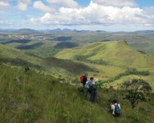 On top of the world! Hikers explore the lush green hills and valleys of Brazil’s stunning landscapes.