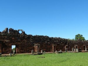 San Ignacio Ruins, Jesuit Mission structures surrounded by lush trees and greenery.