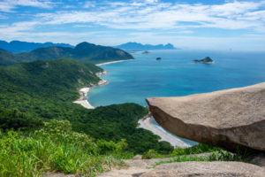 Rio’s Beaches, Coastal Trails & Outdoor Adventures 12 Pedra do Telégrafo rock viewpoint overlooking forest-covered mountains, secluded beaches, islands, and the Atlantic Ocean in western Rio de Janeiro.