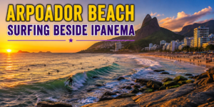 🌊 Best Beaches in Rio De Janeiro – Copacabana, Ipanema& Beyond 4 Arpoador Beach in Rio de Janeiro at sunset with surfers riding Atlantic waves, rocky shoreline, golden sky, Ipanema coastline, city buildings, and dramatic mountains.