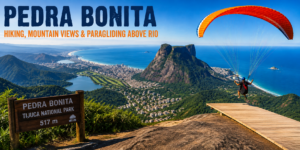 Pedra Bonita overlooking Rio de Janeiro with mountain views, Atlantic coastline, Tijuca National Park forest and a paraglider launching above the city.
